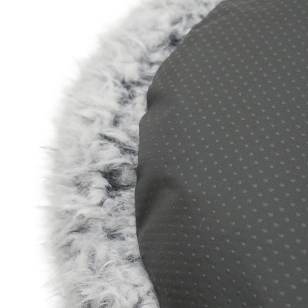 Close-up of the Rosewood Silver Fluff Comfort Round Dog and Cat Bed showing the dark grey non-slip dotted fabric underside next to the soft silver-grey faux fur edging.