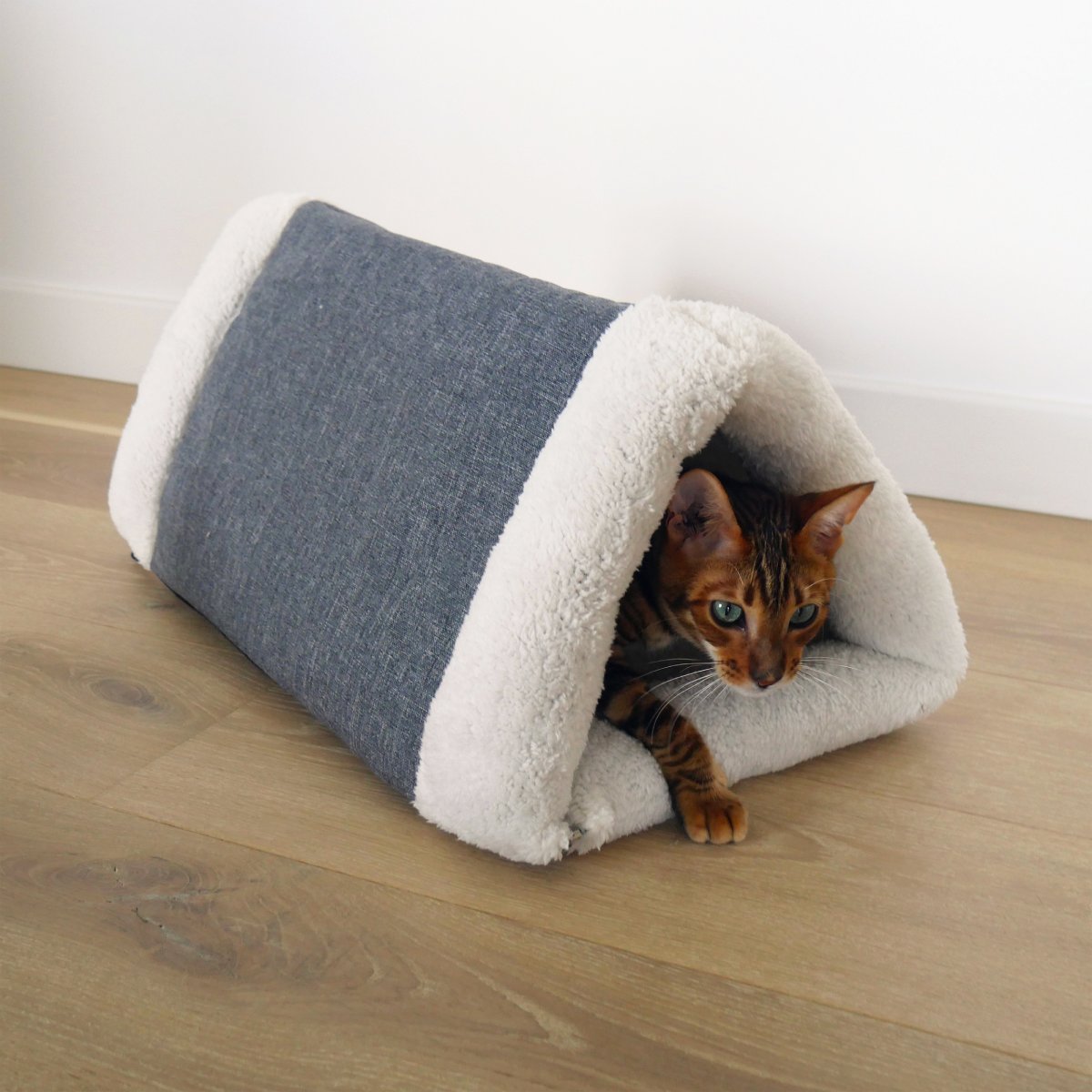 Cat coming out of the Rosewood Snuggle Plush 2-in-1 Cat Comfort Den in a home setting