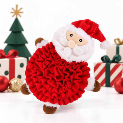 Rosewood Steve Santa Snuffle Mat displayed upright among Christmas presents, showing its red fabric layers, white Santa beard and festive hat.