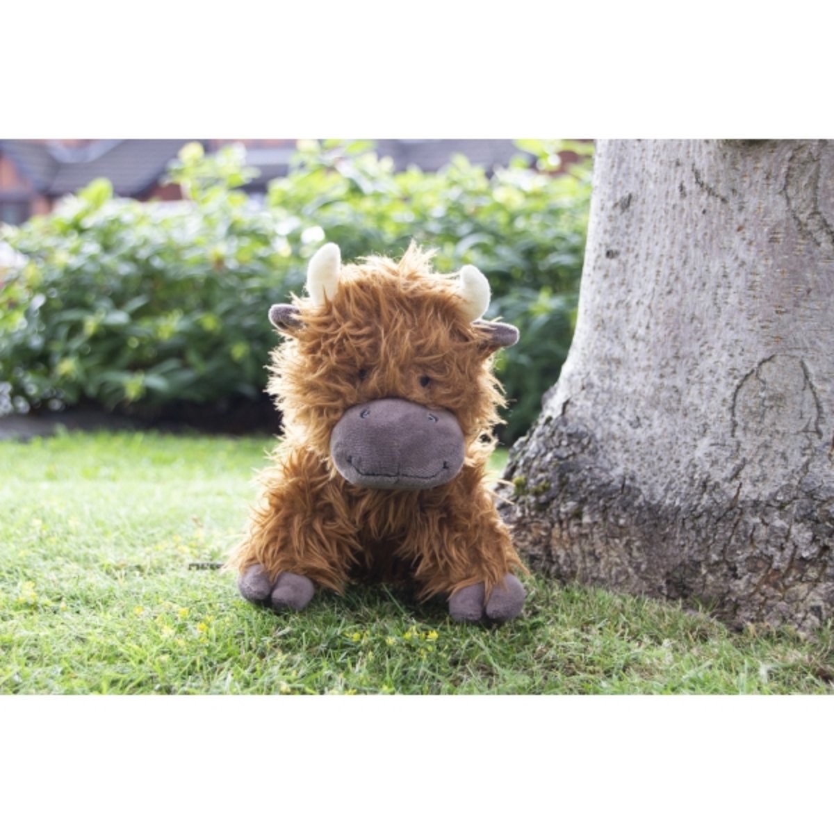 Rosewood Tough Rope Core Cow plush dog toy shown outdoors for interactive play and carrying