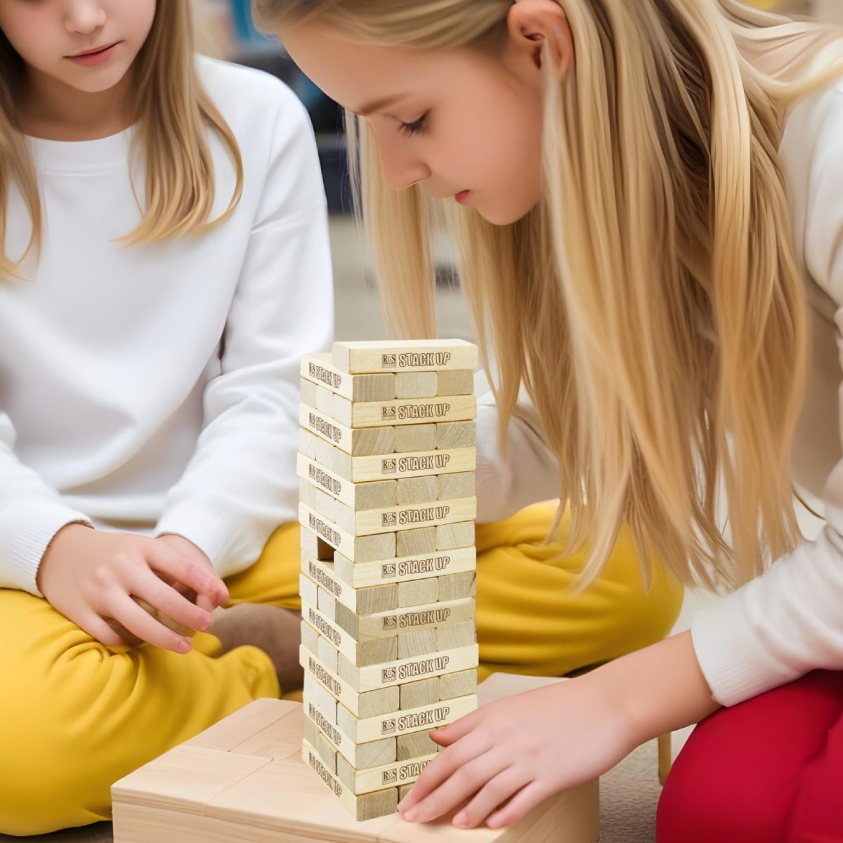 Children playing Stack Up wooden stacking game for family fun and skill building