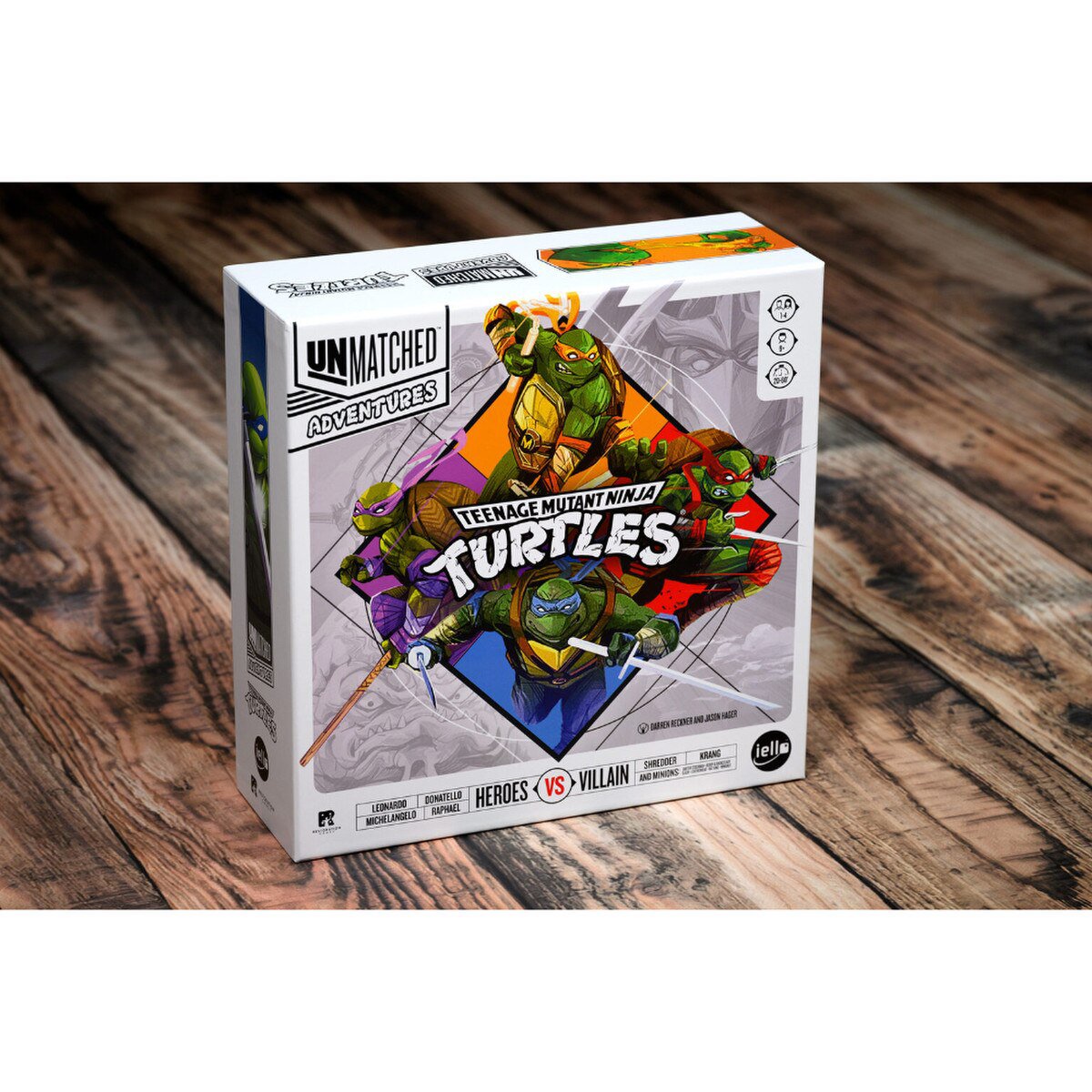 Unmatched Adventures TMNT board game box shown on wooden table for cooperative tactical play