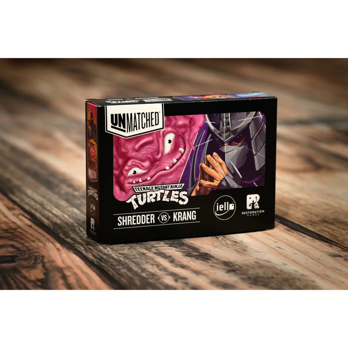 Unmatched Adventures TMNT Shredder vs Krang expansion box on wooden table for Unmatched tactical battles