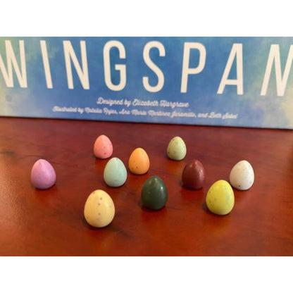Wingspan speckled egg accessory tokens displayed in front of Wingspan game box
