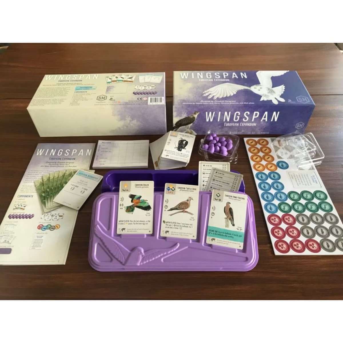 Wingspan European Expansion components with bird cards, purple eggs, food tokens, scorepad and storage tray
